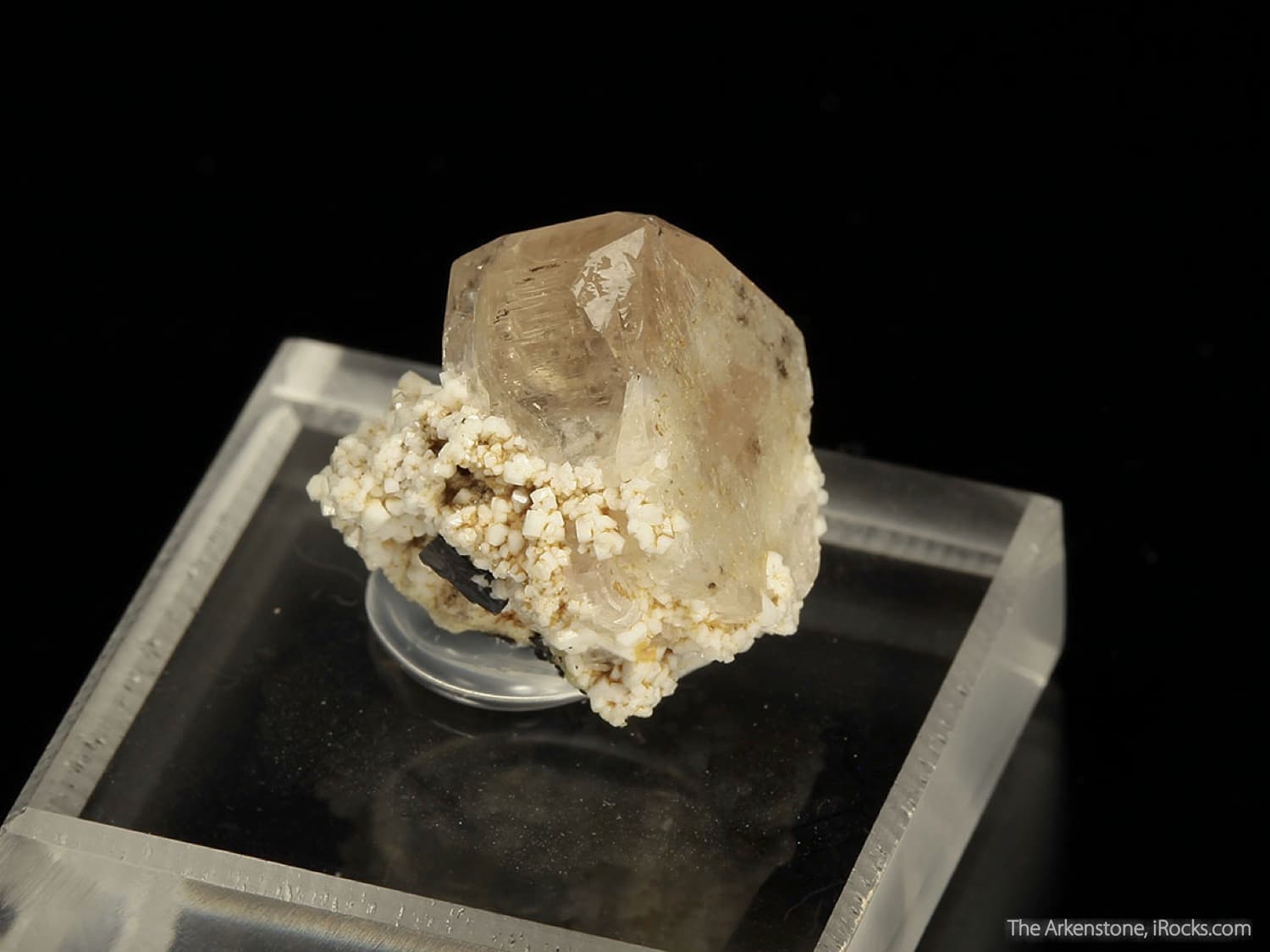 peach-tan zektzerite crystal on matrix